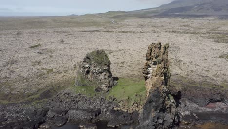 Aerial-of-famous-rock-pinnacles-Londrangar-in-Iceland,-volcanic-plugs-of-basalt