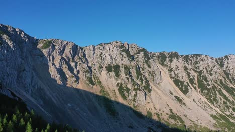 Aerial-View-Of-Mountain-Ridgeline-In-Austria-With-Pedestal-Down-To-Forest-Tree-Line