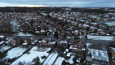 Snowy-aerial-village-residential-neighbourhood-Winter-frozen-North-West-houses-and-roads-pull-back-orbit-right