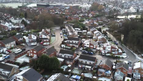 Snowy-aerial-village-residential-neighbourhood-Winter-frozen-North-West-reverse-over-houses-and-roads