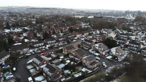 Snowy-aerial-village-residential-neighbourhood-Winter-frozen-North-West-houses-and-roads-reverse-left-pan