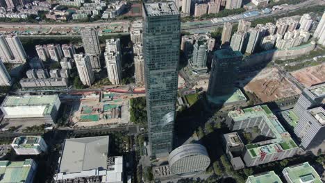 Shenzhen-financial-district-skyscraper-surrounded-by-urban-buildings,-Aerial-view
