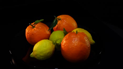 Oranges-and-lemons-on-black-background,-citrus-fruits-with-natural-vitamins