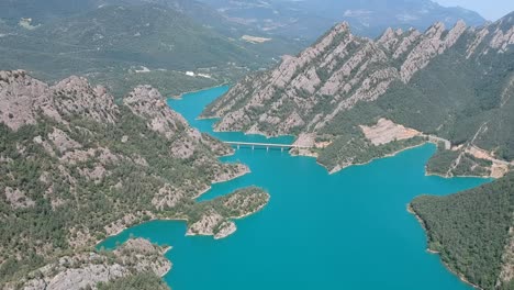 Aerial-views-of-a-lake-in-the-pre-pyrenees-in-Catalonia-with-beautiful-mountains-surrounding-it