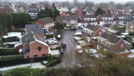 Snowy-aerial-village-residential-neighbourhood-Winter-frozen-North-West-houses-and-roads-low-right-dolly-shot