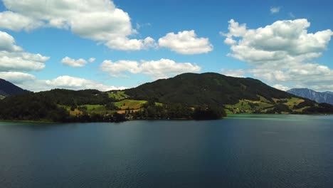 Aerial-view-above-mountain-lake-Mondsee-along-the-coastline-of-Sankt-Lorenz,-Austria