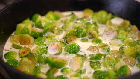 Cooking-Roasted-Sautéed-Brussels-Sprouts-in-a-Cast-Iron-Pan-Skillet---Pouring-Cream---Close-Up-Macro-Shot