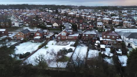 Snowy-aerial-village-residential-neighbourhood-Winter-frozen-North-West-houses-and-roads-track-left