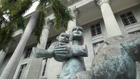 The-Iconic-Mother-And-Child-Sculpture-In-Front-Of-The-National-Gallery-Of-Singapore---Low-Angle-Shot