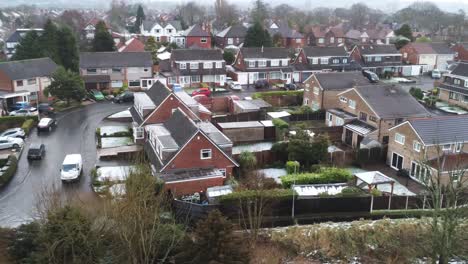 Snowy-aerial-village-residential-neighbourhood-Winter-frozen-North-West-houses-and-roads-low-dolly-right