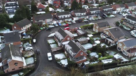 Snowy-aerial-village-residential-neighbourhood-Winter-frozen-North-West-houses-and-roads-birdseye-dolly-right