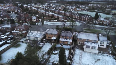 Snowy-aerial-village-residential-neighbourhood-Winter-frozen-North-West-houses-and-roads-birdseye-over-houses