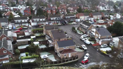 Snowy-aerial-village-residential-neighbourhood-Winter-frozen-North-West-houses-and-roads-birdseye-pull-back-shot