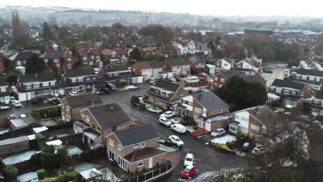 Snowy-aerial-village-residential-neighbourhood-Winter-frozen-North-West-houses-and-roads-push-in
