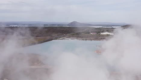 Flying-through-steam-from-geothermal-powerplant-Bjarnarflag-with-blue-lake