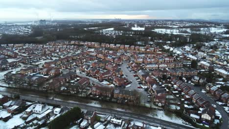 Snowy-aerial-village-residential-neighbourhood-Winter-frozen-North-West-houses-and-roads-high-left-pan-slow