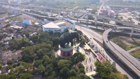 4k-Aerial-Wide-shot-of-the-Erawan-museum-and-a-road-junction-in-Samut-Prakan-Province,-Bangkok,-Thailand