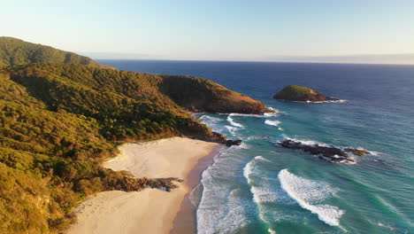 Cinematic-drone-shot-of-North-Smoky-Beach,-the-Ledge-and-Green-Island-near-Smoky-Cape-Lighthouse,-Australia