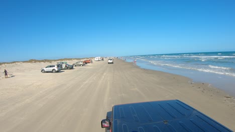 POV-from-top-of-a-slowly-driving-4x4-on-the-beach-at-North-Padre-Island-National-Seashore-near-Corpus-Christi-Texas-USA