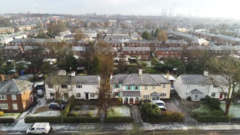 Aerial-view-frosty-white-winter-residential-town-neighbourhood-rooftops-rising-dolly-left