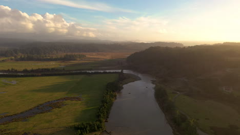 Aerial-flying-over-Sixes-River-course-at-golden-hour,-Cape-Blanco-State-Park