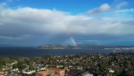 Beautiful-bright-rainbow-over-Tacoma-City-in-Washington-State---Aerial