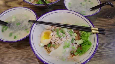 Traditional-Asian-Singaporean-noodles-soup-in-slow-motion-Meepok-with-egg-and-minced-meat-1