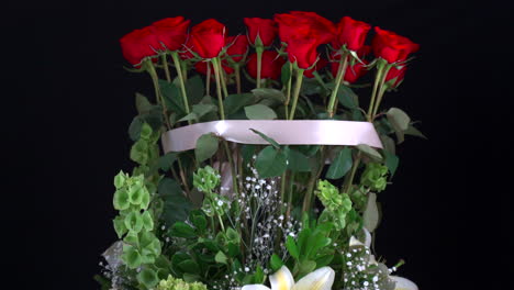Roses-arrangement-with-lilies-lily-spinning-in-black-background