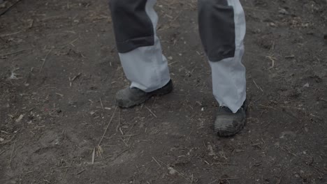 Worker-Walks-On-A-Dirty-Ground-In-New-White-Trousers