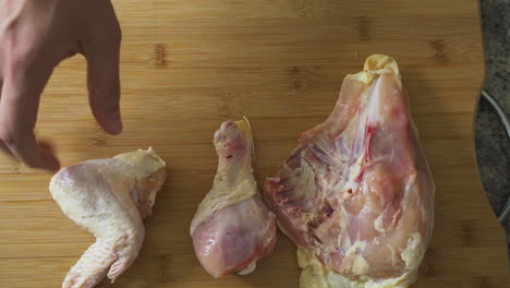Laying-raw-chicken-on-a-cutting-board