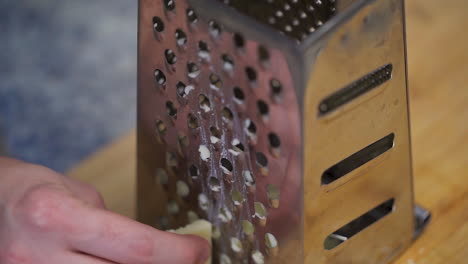 Shredding-cheese-on-a-box-grater