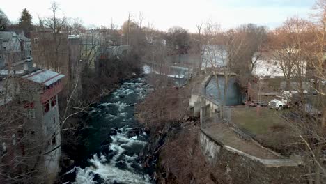 Wappingers-Creek-is-shown-flowing-near-downtown-Wappingers-Falls-in-this-4K-aerial-footage