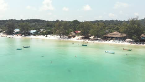 Fly-over-seal-waters-and-approach-beach-bar,-Koh-Rong-Samloem