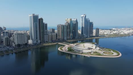 4K:-Sharjah-From-the-Top,-Aerial-view-of-Sharjah-city-and-Khalid-lake,-Al-Majaz-Amphitheatre,-Travel-tourism-business-in-the-United-Arab-Emirates