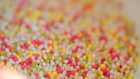 Close-up-view-of-bowl-with-colorful-sugar-sprinkles-dots-for-decoration-for-cake-and-pastry