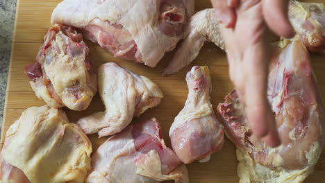 Dusting-salt-over-raw-chicken