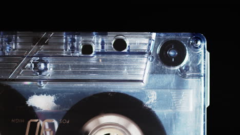 Tape-playing-inside-cassette-then-stopping,-close-up