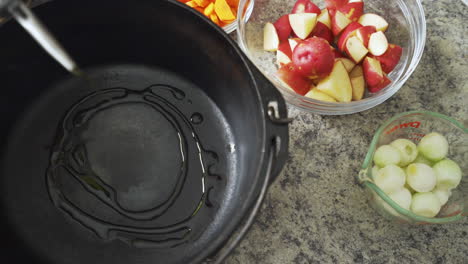 Drizzling-oil-into-a-hot-cast-iron-pot