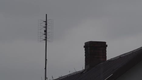 Old-TV-Antenna-On-The-Top-Of-The-Roof-During-Rain-Village