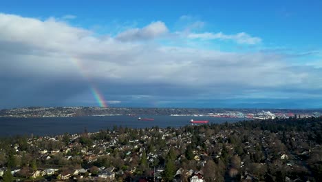 Rainbow-Over-Commencement-Bay-In-Tacoma,-Washington-On-A-Sunny-Day,-wide-aerial-shot