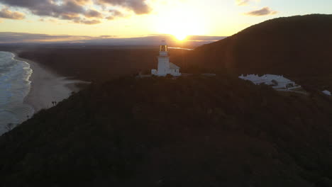 Rotating-drone-shot-of-sunrise-at-Smoky-Cape-Lighthouse-near-South-West-Rocks,-Kempsey-Shire,-New-South-Wales,-Australia