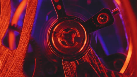 Old-Pocket-Watch-Moving-Mechanism-In-Red-Light,-macro