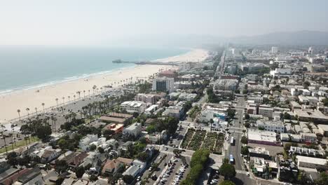 Flying-drone-backwards-revealing-the-Venice-and-Santa-Monica-Beach-line
