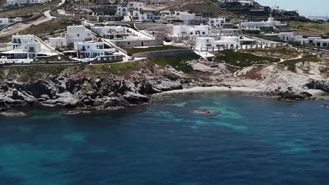 Aerial-Drone-Moving-Forward-Pan-Down-On-Blue-Beach-Mykonos
