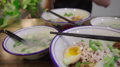 Traditional-Asian-Singaporean-noodles-soup-in-slow-motion-Meepok-with-egg-and-minced-meat-2