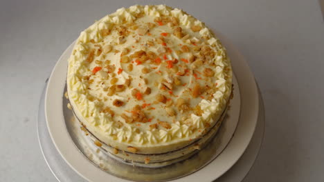 Tempting-Carrot-Walnut-Cake-On-A-Rotating-Cake-Stand,-top-view,-studio-shot