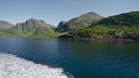 Traveling-by-boat-by-the-rocky-mountain-shoreline-of-Norway---Slow-motion