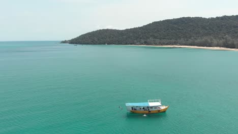 Holidaymakers-enjoying-calm-turquoise-sea-on-boat,-Koh-Rong-Samloem,-M'pai-bay,-Cambodia