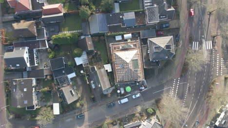 Top-down-aerial-of-house-rooftop-under-construction---drone-setting-down-and-spinning