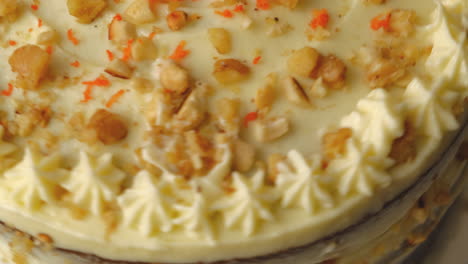 Delicious-Carrot-Cake-With-Chopped-Walnuts-And-Fresh-Carrot-Bits-On-Top,-macro